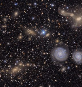 This image shows another small section of nsf doe vera c. rubin observatory's total view of the virgo cluster. visible are two prominent spiral galaxies (lower right), three merging galaxies (upper right), several groups of distant galaxies, many stars in