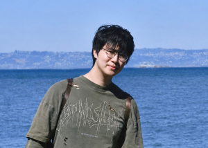 Haoyan Haoyan poses in front of a large body of water